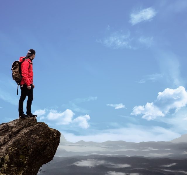 guy-looking-out-over-mountain Climber looking out over mountain