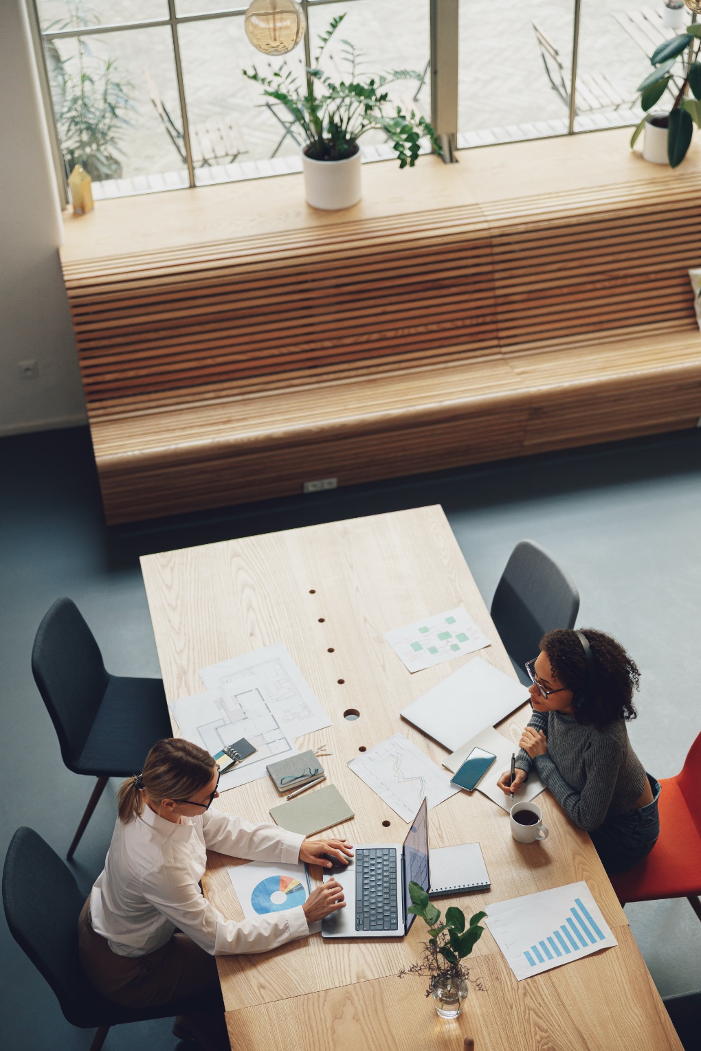 Woman office worker discussing new project with colleague in coworking. High quality photo